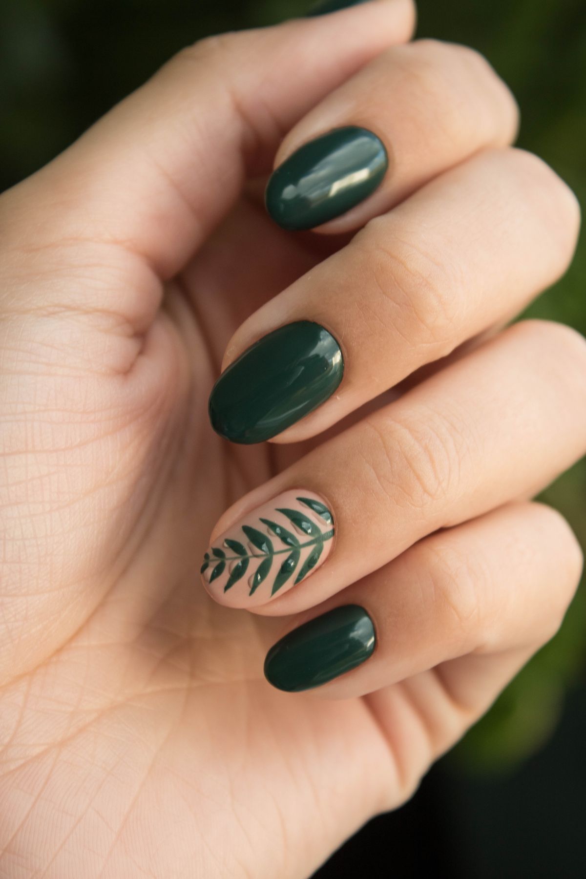 Green nail art manicure with leaf design